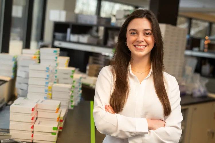 Lily Felten stands amidst blood testing kits