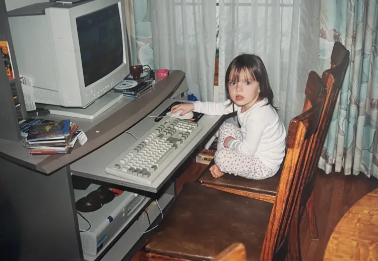 Bryn Loftness as a toddler sits at her parents' computer