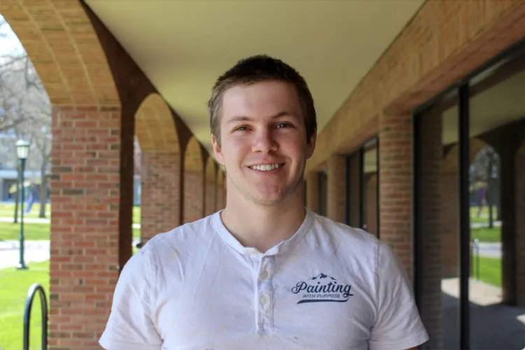 Zach Dunn standing at the Grossman School of Business