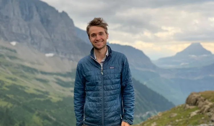 Harold Eyster flanked by steep Western mountains