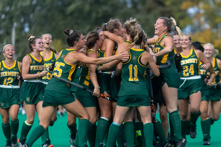 uvm field hockey team celebrates a win together