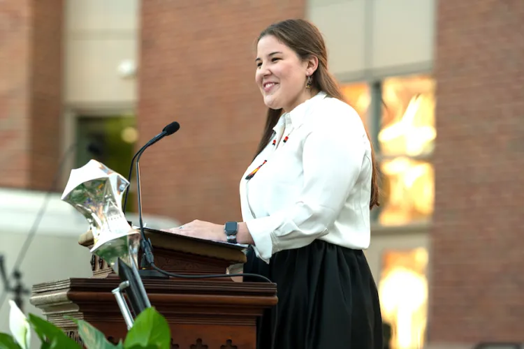 Maddie Henson speaking at a lecturn