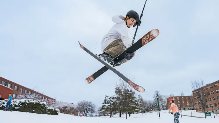 a skiier flies through the air