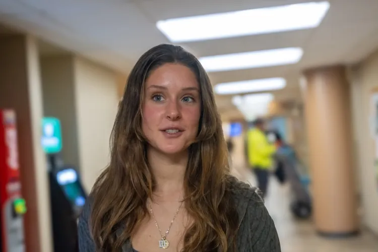 Sydney Webster standing in a Davis Center hallway