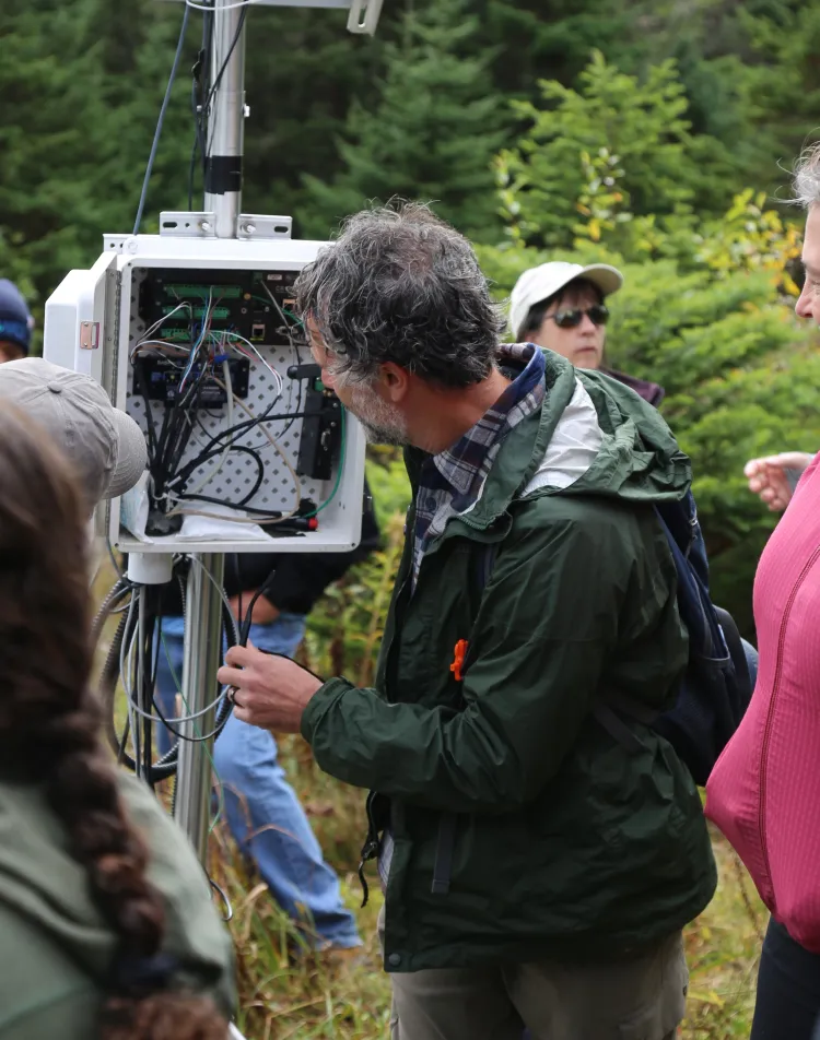 The group gets an introduction to the Mount Mansfield measurement station. 
