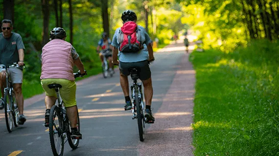 People ride bikes on the bike path