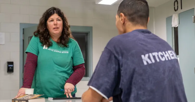 Abigail Crocker from the Justice Research Initiative interviews a prisoner