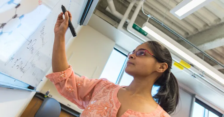 Graduate student Sengupta Sanghita works out a Physics problem on the whiteboard