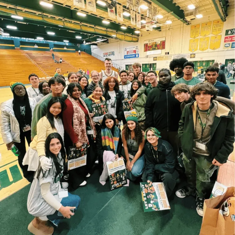 Group of students poses together in the gym