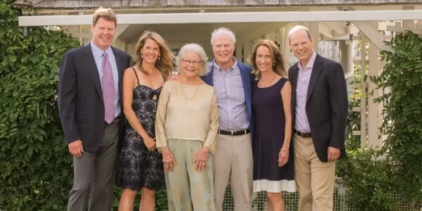 A group of people in dressy clothing standing together