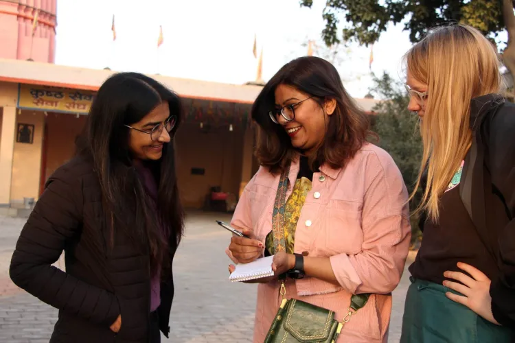 Two students journalists relax with a student photographer between interviews at a leper colony in Kaithal, Haryana.