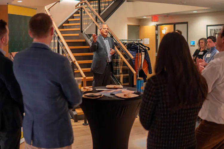 Dean Sanjay Sharma addresses the audience at the Champlain Investment Partners event.