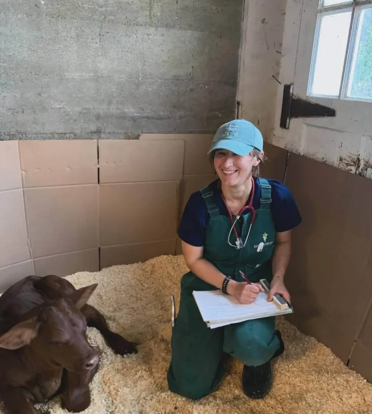 Dayna Locitzer checking up on a young calf