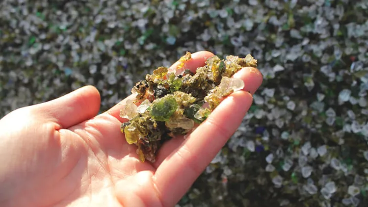 Hand displaying roadway aggregate sample