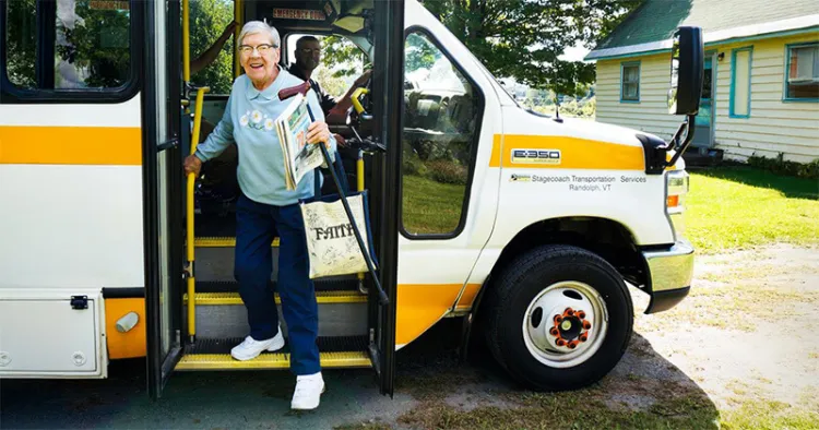 a rural transit rider disembarks at her home