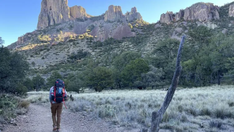 Chris hiking next to massive rock formations