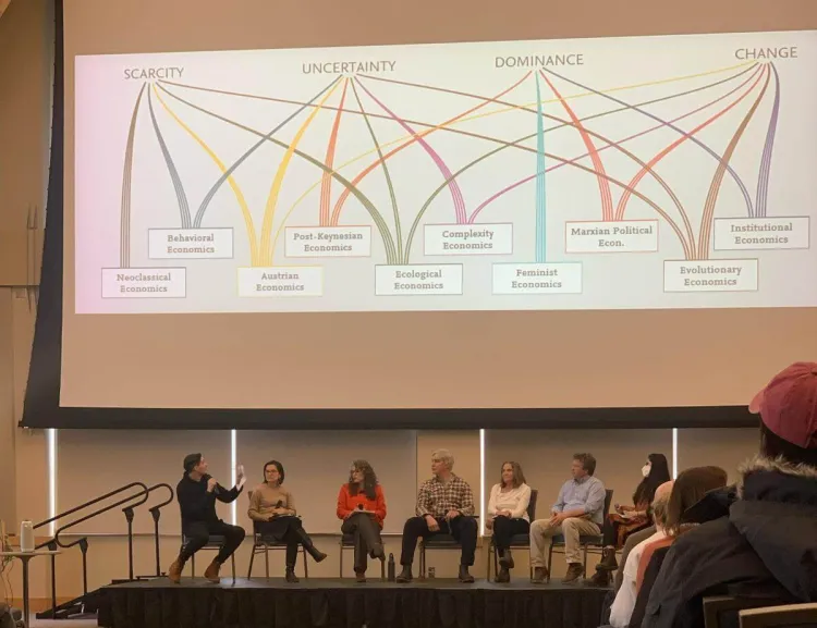 Rigo Melgar explaining a diagram on the big screen at the event