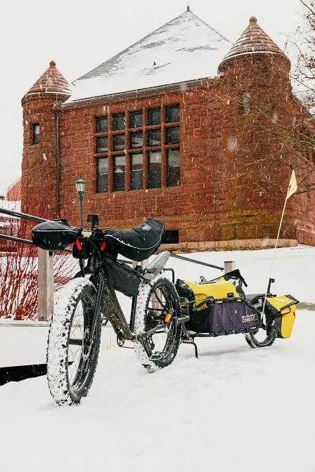 A bike in the snow outside of the memorial service at Ira Allen chapel