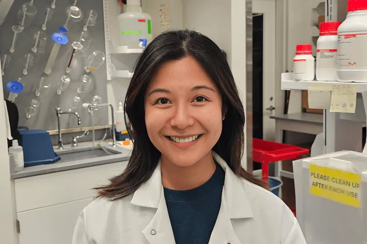 a woman in a lab smiling
