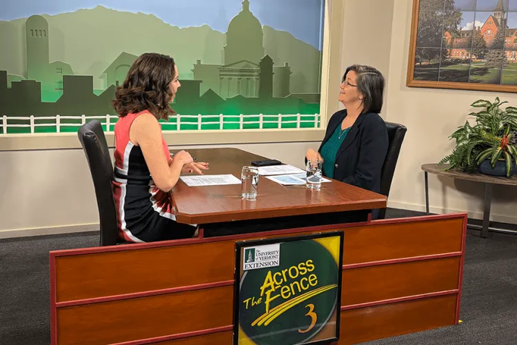 two women sitting at a table talking