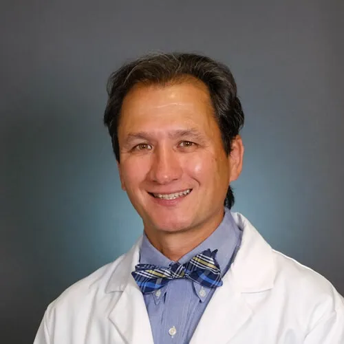 man in doctors coat smiling