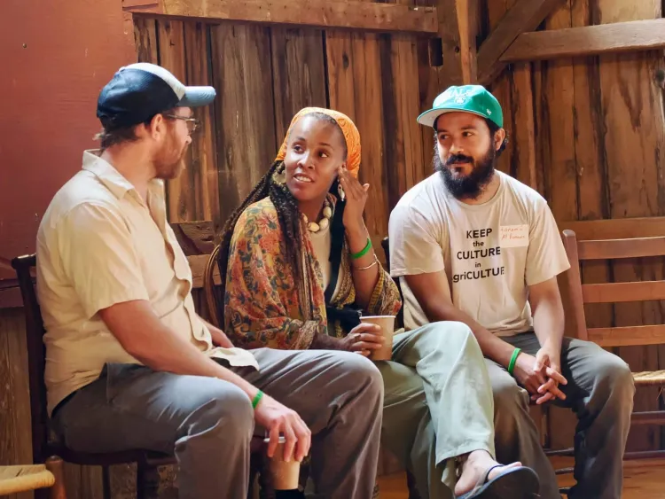 Graham Unangst-Rufenacht, policy director for Rural Vermont (left), speaks with Amber Tamm, head florist at the Catamount Farm, and tanamá varas, Catamount Farm Manager and FTP Lead Instructor.