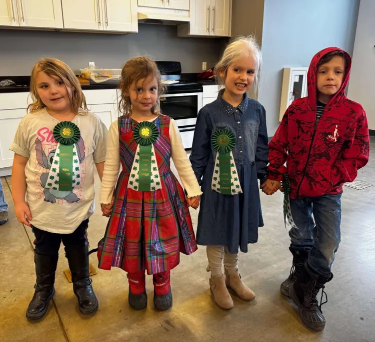 4 kids with prize ribbons