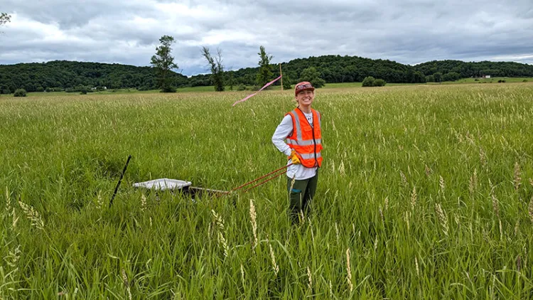 Environmental Engineering Student Victoria Horton ’25 collects vegetation samples in the Lake Champlain watershed.