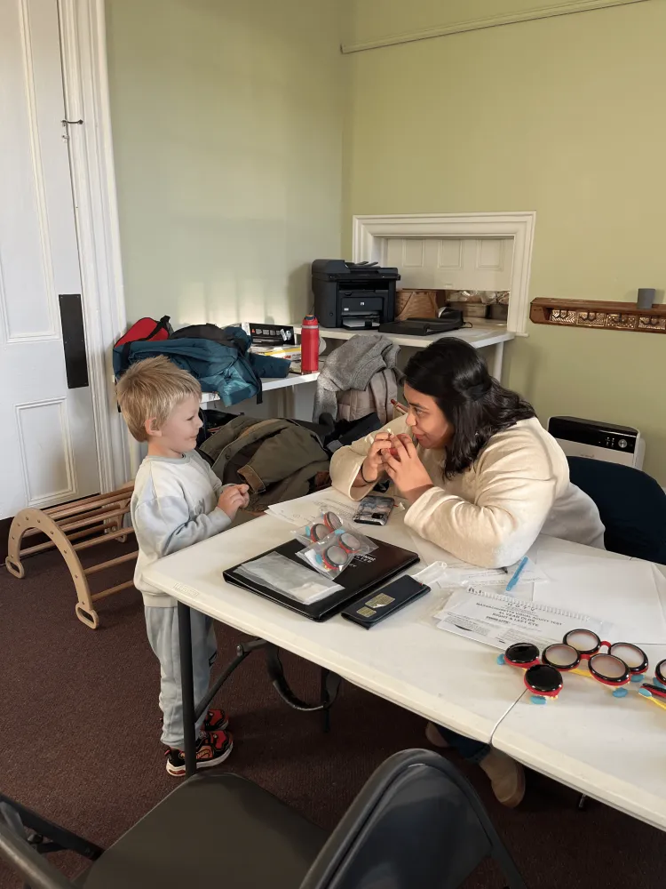 A young boy and adult woman play together