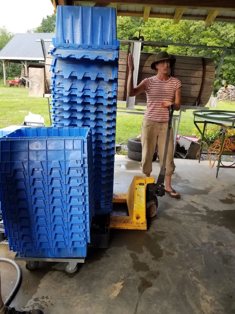 stacked plastic bins on dollies