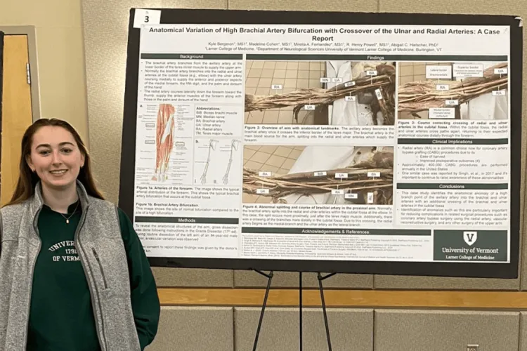 a woman standing with her research poster