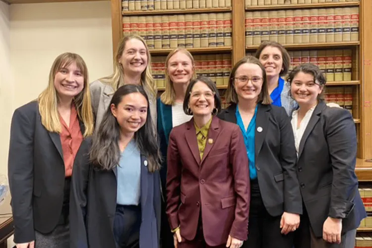 a group of women in professional dress in a library
