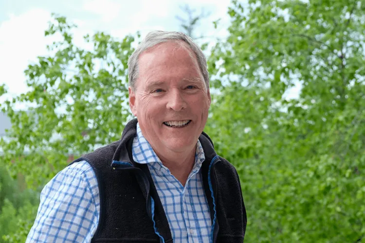 a man outside smiling