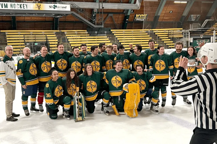 a hockey team posing on the ice