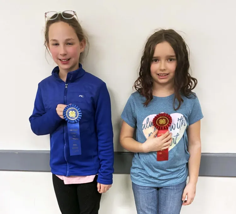 two kids holding ribbons