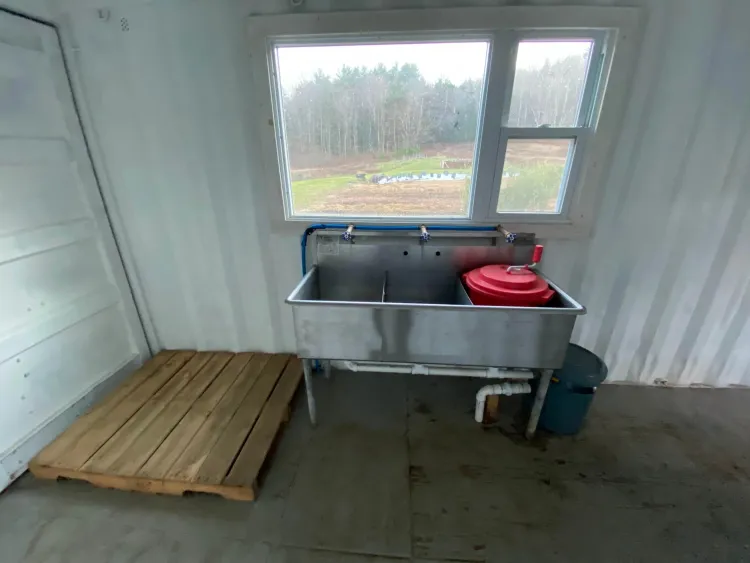 wooden pallet next to a large metal sink