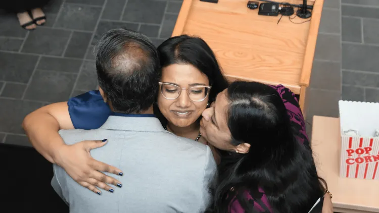 a woman hugs her parents