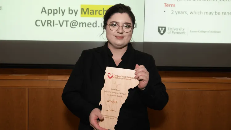 a person holding an award plaque
