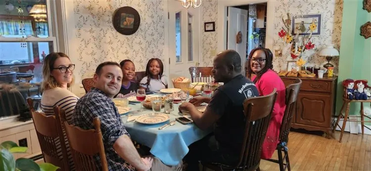 Students enjoying Thanksgiving meal with hosts
