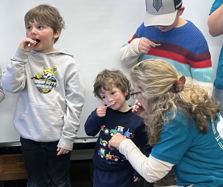kids tasting maple syrup