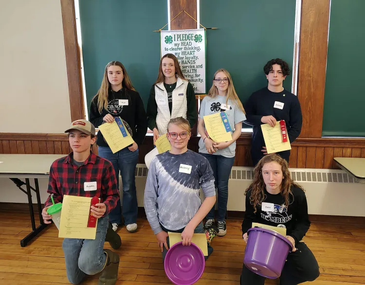 group of 4-H'ers posing with certificates and ribbons