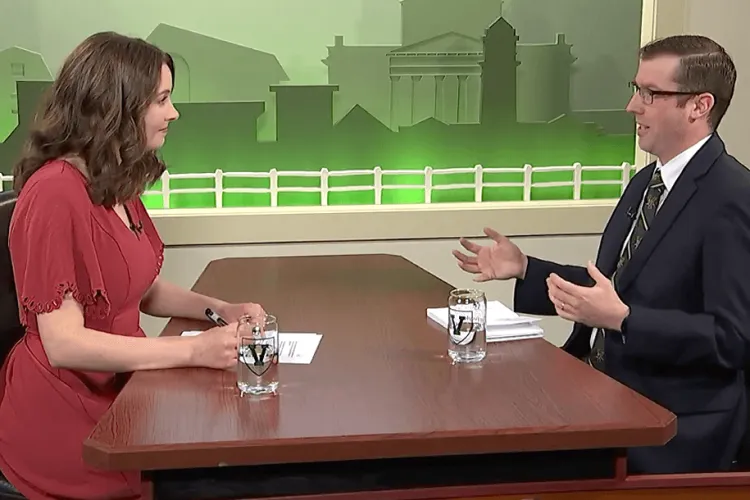 a woman and a man speaking across a table