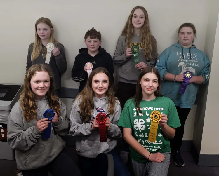 7 kids holding ribbons