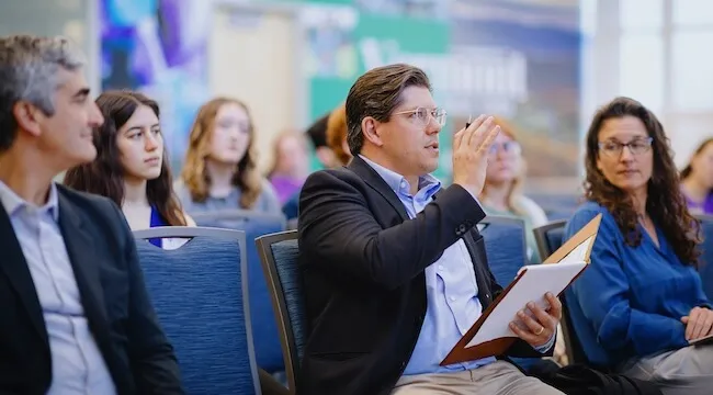 Audience members ask questions of student presentations