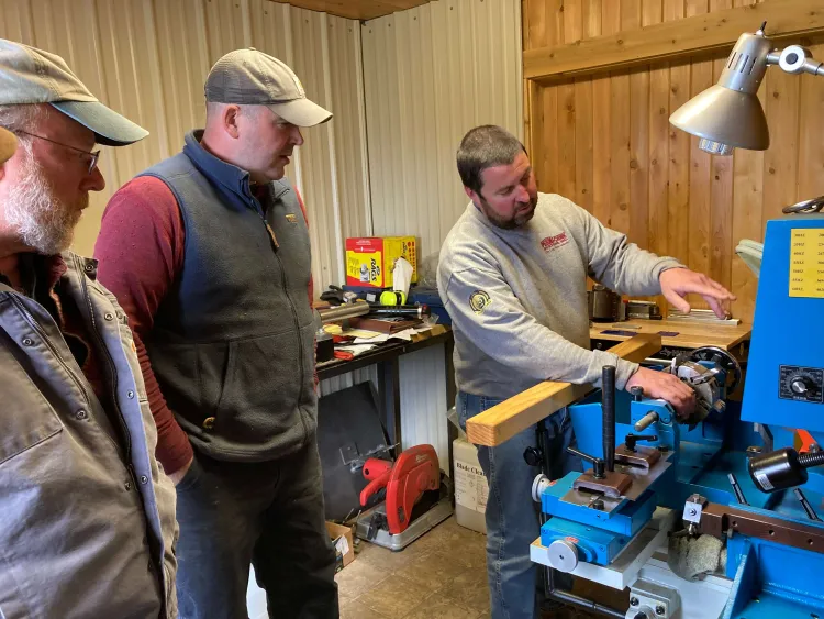 3 people at some machinery