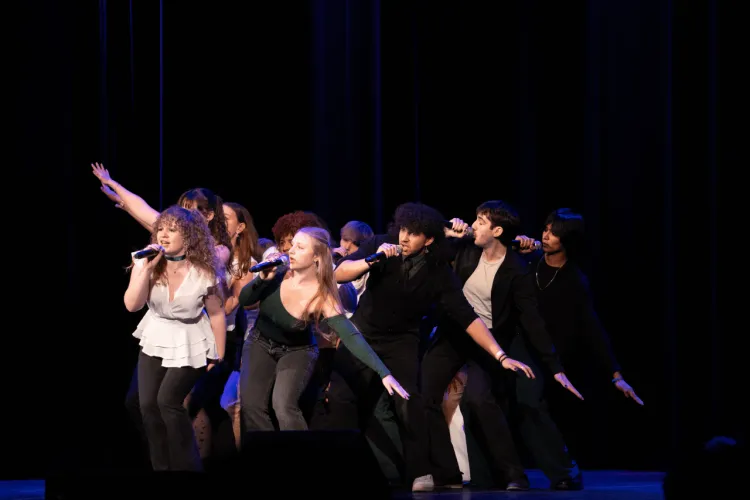 A cappella group singing on stage