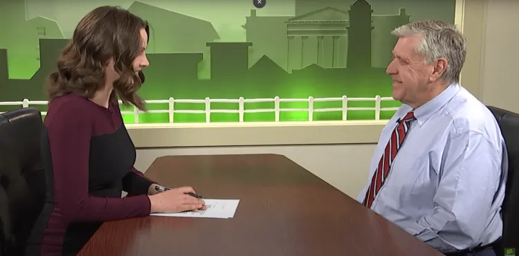 a woman and a man talking at a table