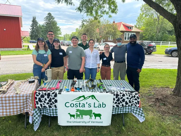 A group of students who work together in the Costa Lab with a table presentation