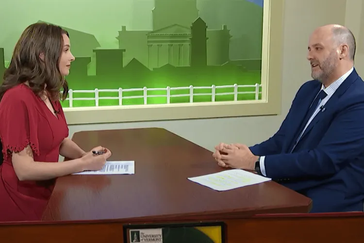 a woman interviewing a man across a desk
