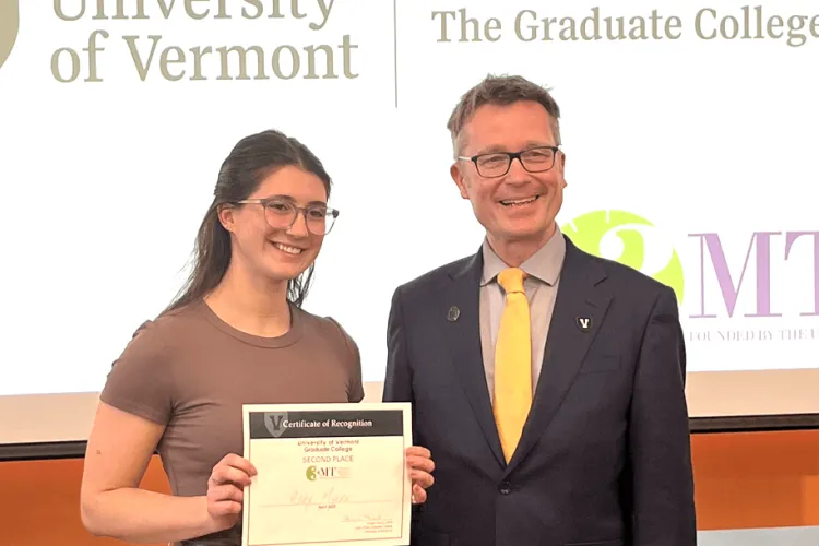 a woman holding an award and a man smiling